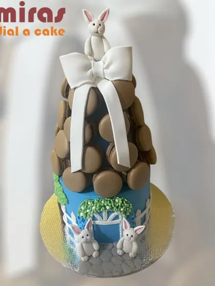 A whimsical macaron tower cake. This unique design features a tower of chocolate macarons with a cute bunny on top, creating a playful and elegant alternative to a traditional cake.
