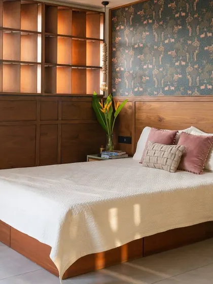 The bed is positioned to feel like it's floating between the screens, creating a unique and dynamic bedroom layout.