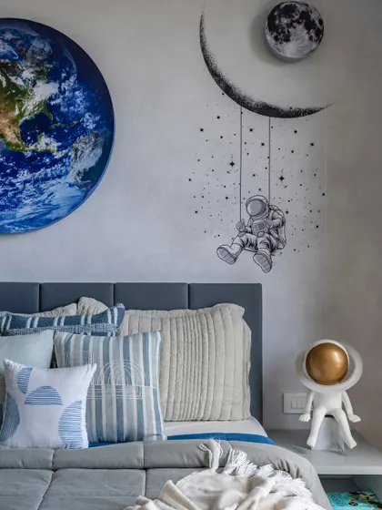Another angle of the space-themed room, showcasing the vivid Earth mural and the astronaut swinging among the stars, creating an inspiring space for big dreams.