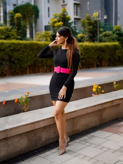 This pose shows the full silhouette of the dress, demonstrating how we capture fashion in a natural, urban environment.