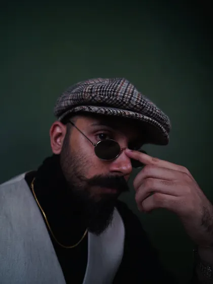 Adjusting the sunglasses in this shot adds a bit of character. It's a great example of a subtle, natural pose for a men's accessory or portrait photoshoot.