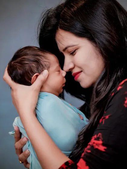 The beginning of a beautiful story. This portrait captures the tender, quiet moment between a mother and her newborn, a memory to cherish forever.