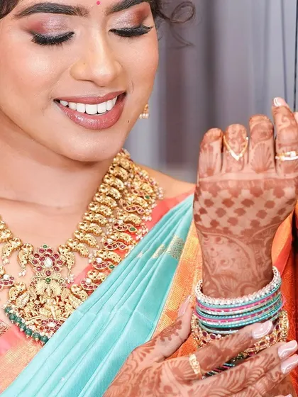 A close-up of the beautiful details. The soft makeup, intricate henna, and colorful bangles all come together for a perfect engagement look.