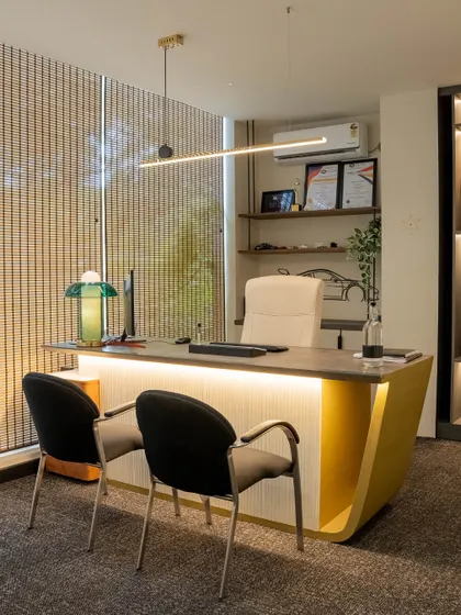 This executive desk combines a textured front panel with a bold yellow curve, creating a statement piece. Sleek lighting and open shelving add to the modern, functional design.