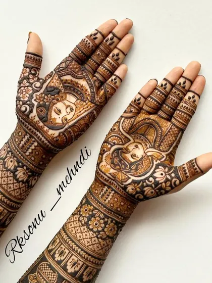 This design features a portrait of the bride on one hand and a depiction of Lord Ganesha on the other, invoking blessings for her new journey. The arms are covered in dense, traditional patterns.