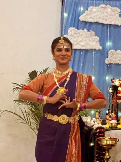 Another still from the Shivratri performance, showing a traditional pose in front of the beautifully decorated temple setup.