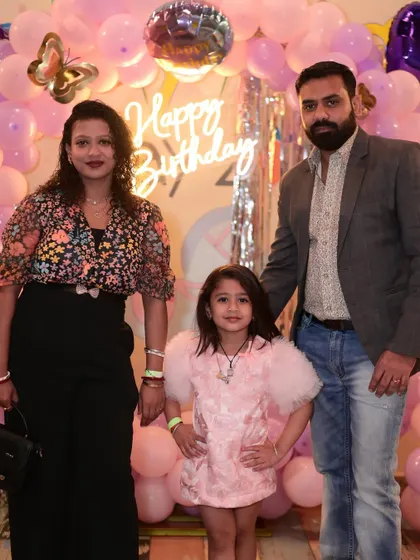 A beautiful family portrait in front of a pink butterfly-themed balloon backdrop. We provide plenty of photo-worthy spots for you to capture your memories.