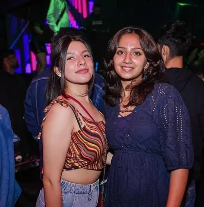Friends enjoying a night out, with the music setting the perfect mood.