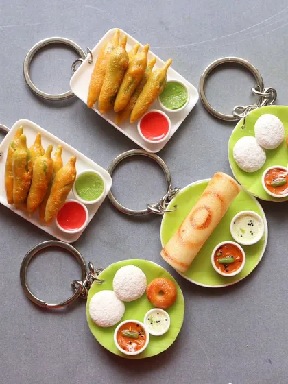 A collection of South Indian breakfast and mirchi bajji keychains, perfect for carrying a piece of your favorite food with you.