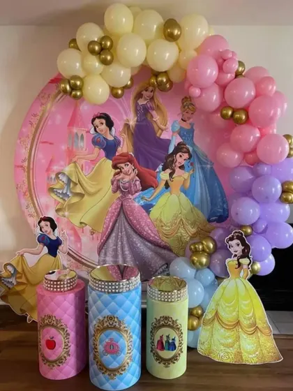 A Disney Princess themed birthday party. This decoration includes a large circular backdrop with all the princesses and themed plinths for a royal celebration.