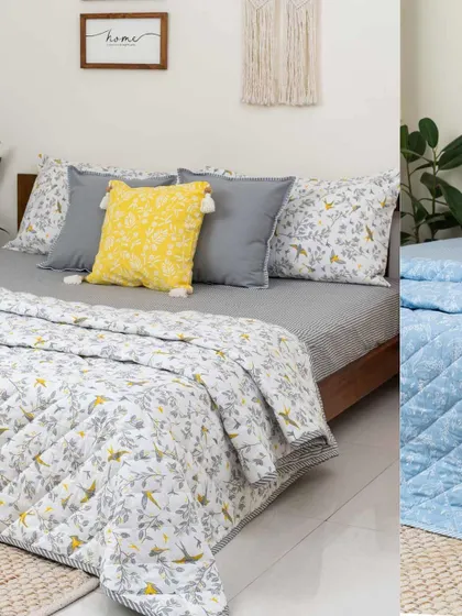 Another beautiful bedding combination. Here, our 'Winged Skies' quilt is paired with a grey striped fitted sheet and a pop of color from a yellow tassel cushion, creating a balanced and modern look.