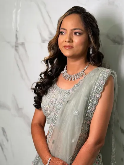 The bride looking away, giving a beautiful profile of her makeup and hairstyle. The look is perfect for a day or evening engagement ceremony.