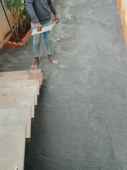 A view from the top of the stairs showing the fully prepared and smoothed base layer ready for turf.