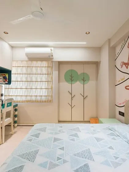 A child's room designed to be both functional and inspiring. The custom study unit, wardrobe with playful tree motifs, and vibrant wall art create a space that encourages creativity and feels personal.