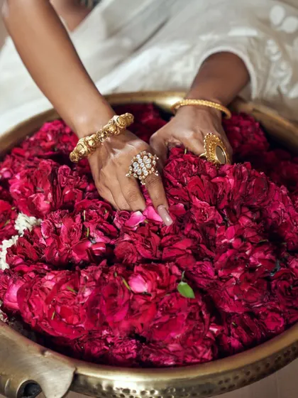 This sensory image connects the luxury of the jewelry with the natural beauty of rose petals. It’s a detail shot that adds a layer of texture, color, and emotion to the fashion campaign.