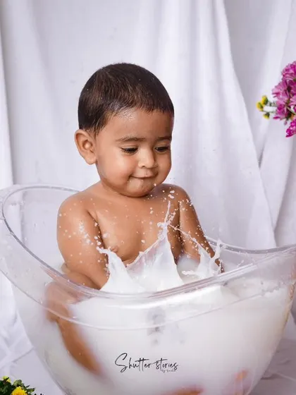 Splash time! After the cake smash, a milk bath is the perfect way to clean up and capture some more adorable, playful moments.