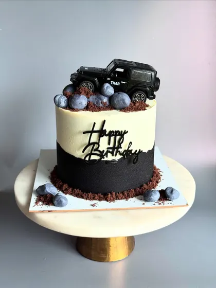 A still image of the rugged and stylish Thar-themed cake, complete with edible chocolate "mud" and rocks.