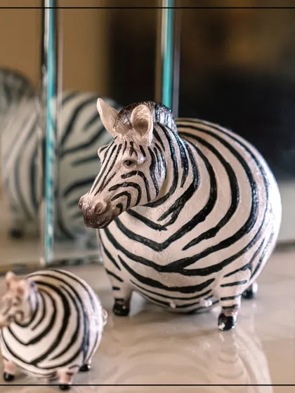 Unveil the mystery of luxe interiors with my Wild Noir Collection. This quirky zebra figurine is a perfect example of the collection's bold fusion of nature's raw essence and sleek, modern design.