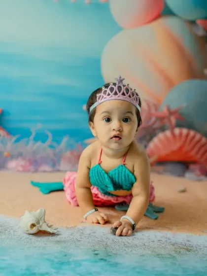 Capturing the crawling stage in a unique way. This little mermaid explores her sandy shore, creating a dynamic and adorable action shot.
