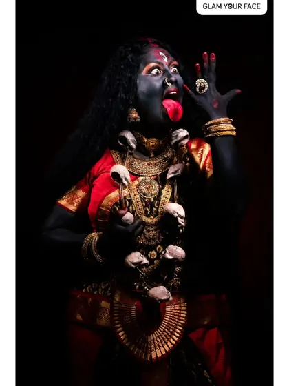The fierce expression of Goddess Kali. This image captures the intensity of the character, brought to life through dramatic makeup and styling.