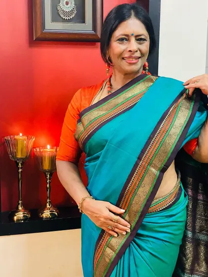 For Day 8, I wore a 30-year-old classic Kanjeevaram in peacock green, a gift from my mother-in-law. Paired with an orange blouse, it feels timeless.