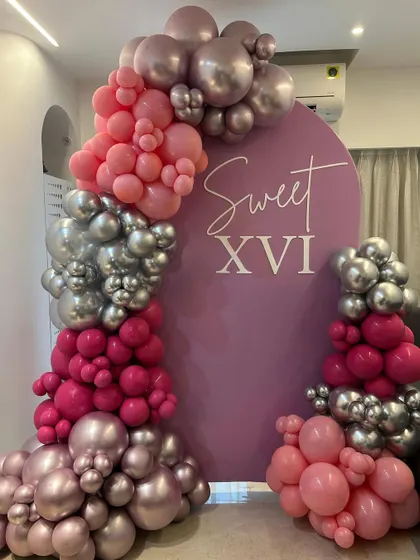 A "Sweet XVI" single panel setup. The combination of pink and silver chrome balloons creates a chic and modern look for a 16th birthday.