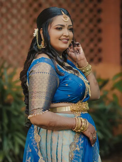 A stunning engagement look for a doctor couple in Mysore. The bride wore a beautiful blue half-saree, and we created a soft, glowing makeup look to complement it.