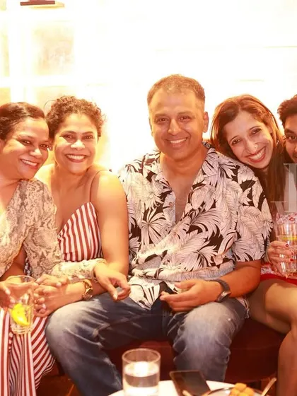 A group of friends enjoying the festive atmosphere at our Women's Day social. It's all about community and celebration.