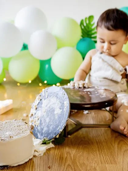 And... we have a flipped cake! The aftermath of a cake smash is often as fun as the beginning. This photo captures the hilarious reality of a one-year-old's encounter with his birthday cake.