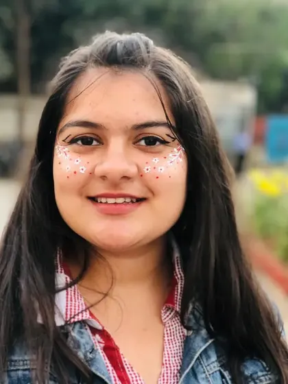 A full-face floral look with tiny white flowers scattered across the cheeks and nose, connected by a winged eyeliner.