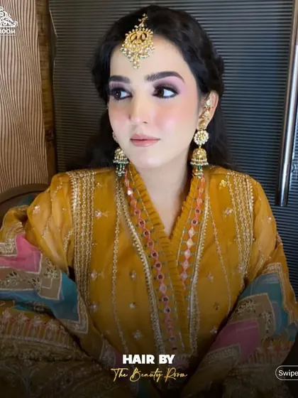 This hairstyle is perfect for showcasing a maang tikka, as seen on this client for her festive look.