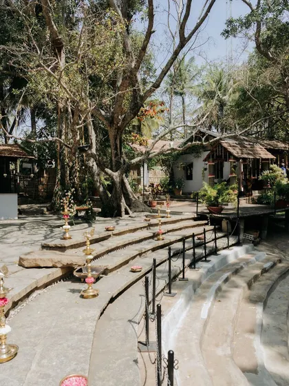 The stone steps of the amphitheater, lined with traditional brass lamps, create a beautiful pathway for a ceremony.