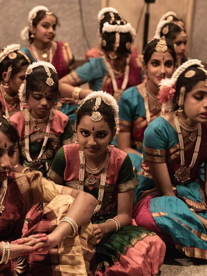 A group of young dancers waiting for their turn, showcasing the discipline and patience taught through classical dance.