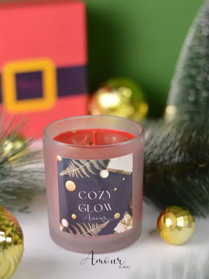 The 'Cozy Glow' jar candle, with a warm vanilla and cinnamon scent and a sophisticated, starry night label design.