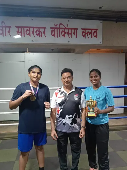 Back at the club with my medal-winning boxers from the Youth Women State Championship. We bring the trophies and medals back to our akhada.