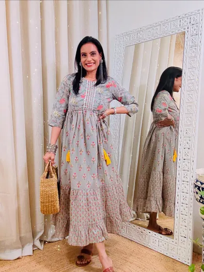 A grey printed tiered maxi dress. This is a comfortable and elegant dress that is perfect for a relaxed day.