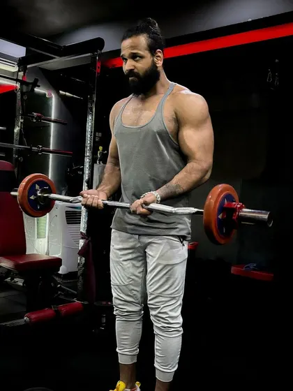 Make yourself a priority. An EZ bar curl in the squat rack, focusing on form to build bicep peaks.