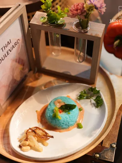 Crafted for joy, served with care. Our Thai Boulevard special, a beautifully plated dish of blue pea flower rice with Thai curry, offers an authentic taste of Southeast Asia.