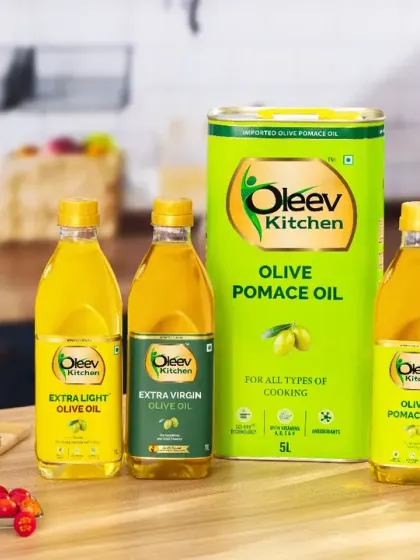 A full product family shot for a cooking oil brand, styled in a warm and inviting kitchen setting. We included fresh bread and olives to place the products in a realistic, appealing context, showing how they fit into a customer's home.