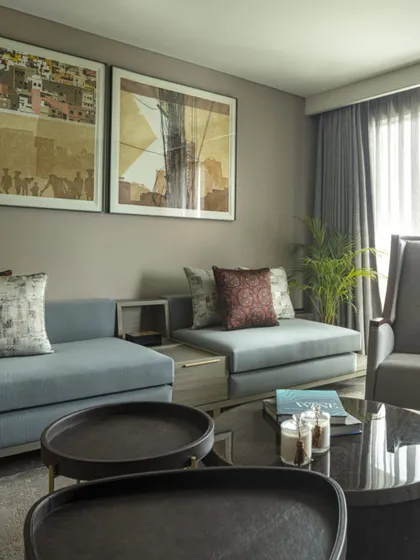 A cozy seating nook within the Jor Bagh Residence. This space is designed for intimate conversations, with comfortable low-slung sofas, curated art, and soft lighting.