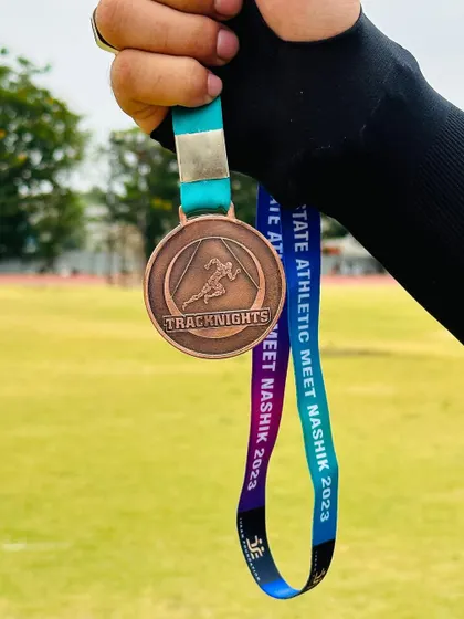 A TrackNights medal, a symbol of where hard work meets recognition. We celebrate the determination of our young athletes.