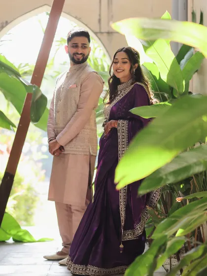 A candid moment captured between Devanshi and Anshul before their ceremony. Framed by lush greenery, this photo shows a quiet, stolen moment of connection away from the crowds.
