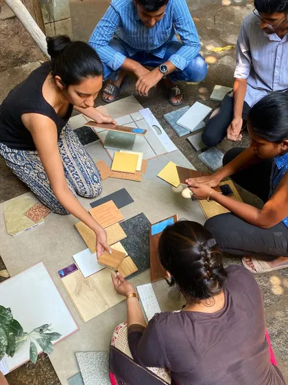 Our team and clients gather in the studio courtyard to create a material palette. This hands-on, collaborative session is a crucial part of our design process, ensuring the final home reflects the client's personal style.