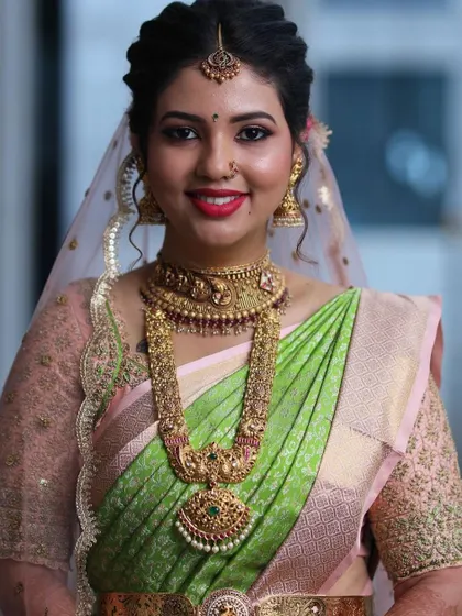 A lovely close-up of my bride. You can see the detail in the sheer embroidered sleeves of her pastel pink blouse, designed for her reception.