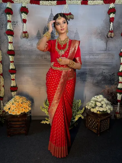 The bride looks like a goddess in this classic red Kanchivaram. The drape is powerful and regal, perfect for a temple wedding setting.