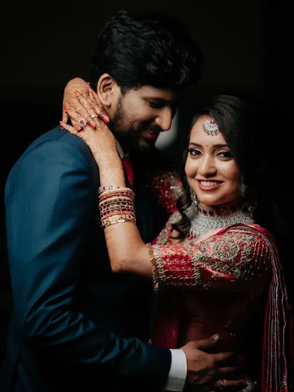 A classic and elegant portrait of the couple in their reception attire, their smiles radiating happiness.
