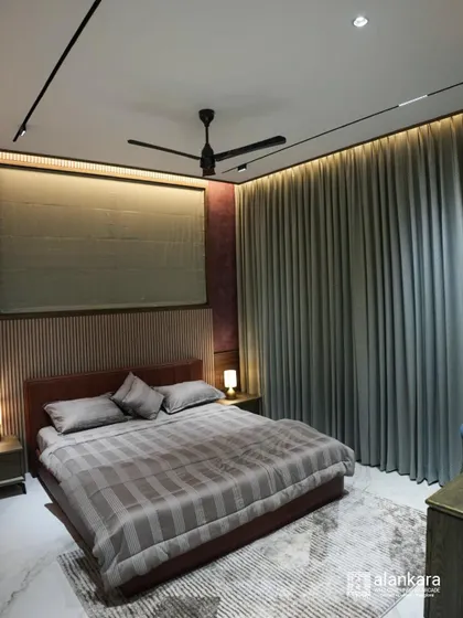A cozy bedroom featuring floor-to-ceiling curtains and a matching Roman blind. The custom bed and warm lighting create a comfortable and relaxing atmosphere.