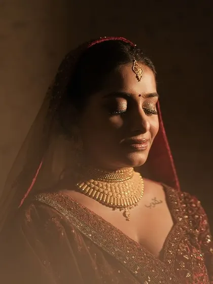 A quiet, beautiful moment captured by the photographer. This is the essence of my work: creating a look so perfect and personal that the bride feels completely at peace and radiant in her own skin, glowing in the golden light.