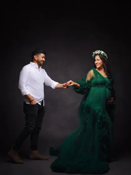 A playful and romantic couple's portrait. The husband-to-be takes his partner's hand as if asking for a dance.