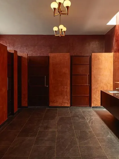 Even utilitarian spaces can be designed to deliver a powerful experience. For this event venue, I used a rich, monolithic color scheme, dramatic lighting, and symmetrical design in the restroom to create an unexpectedly artistic and memorable moment for guests.